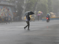 A man is crossing a road during heavy monsoon rain in Kolkata, India, on July 15, 2024. (