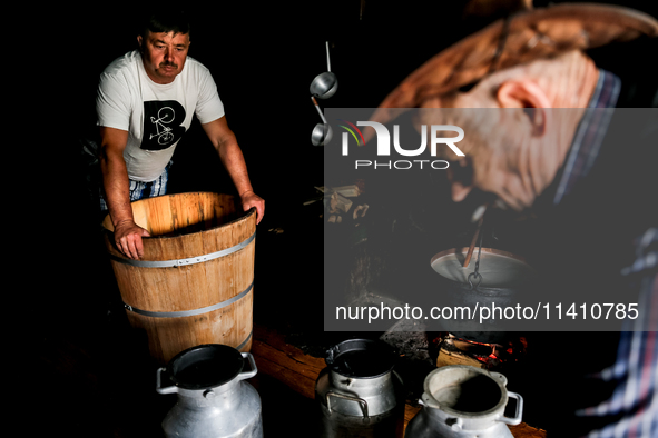 Baca Krzysztof Las (a traditional Polish Carpathian mountains shepherd) prepares sheep milk to make cheese in Traditional wooden shepherd ho...