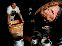 Baca Krzysztof Las (a traditional Polish Carpathian mountains shepherd) prepares sheep milk to make cheese in Traditional wooden shepherd ho...