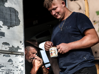 Adrian, son of Baca Krzysztof Las (a traditional Polish Carpathian mountains shepherd) and Wojtek (Juhas) rest after milking sheep at sunris...