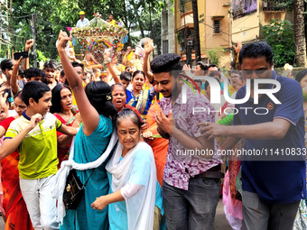 Devotees are taking part in a procession of Ulto Rath Yatra (Return Chariot Procession) in Siliguri, India, on July 15, 2024. (