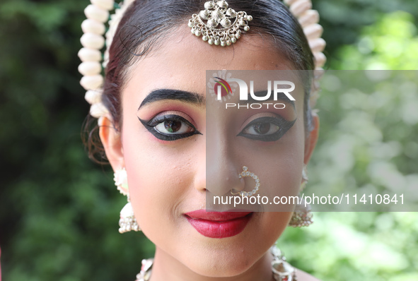 An artist is posing for a picture as she is waiting to perform on the last day of the week-long celebration of Rath Yatra, or chariot proces...