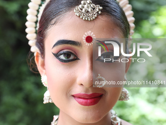 An artist is posing for a picture as she is waiting to perform on the last day of the week-long celebration of Rath Yatra, or chariot proces...