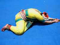 An artist is offering prayer after performing on the last day of the week-long celebration of Rath Yatra, or chariot procession, in Kolkata,...