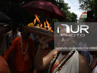 A Hindu priest is worshipping the idol of Lord Jagannath on the last day of the week-long celebration of Rath Yatra, or chariot procession,...