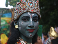 An artist is dressing as Hindu Lord Krishna as he is waiting to perform on the last day of the week-long celebration of Lord Jagannath's ''R...