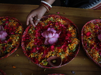 A Hindu devotee is preparing trays of offerings before she participates on the last day of the week-long celebration of Rath Yatra, or chari...