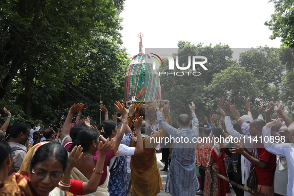 Hindu devotees are raising their hands and shouting religious slogans on the last day of the week-long celebration of Rath Yatra, or chariot...