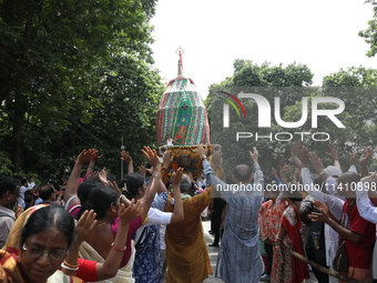 Hindu devotees are raising their hands and shouting religious slogans on the last day of the week-long celebration of Rath Yatra, or chariot...