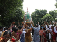 Hindu devotees are raising their hands and shouting religious slogans on the last day of the week-long celebration of Rath Yatra, or chariot...