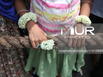 A Hindu girl is holding a rope to pull a ''Rath'', or the chariot of Lord Jagannath, to seek blessings on the last day of the week-long cele...