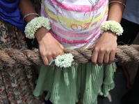 A Hindu girl is holding a rope to pull a ''Rath'', or the chariot of Lord Jagannath, to seek blessings on the last day of the week-long cele...