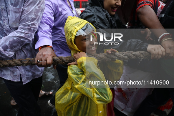 A Hindu boy is pulling a ''Rath'', or the chariot of Lord Jagannath, to seek blessings on the last day of the week-long celebration of Lord...