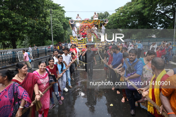 Hindu devotees are pulling the ''Rath'' or the chariot of Lord Jagannath, on the last day of the week-long celebration of Rath Yatra, or cha...