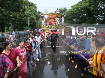 Hindu devotees are pulling the ''Rath'' or the chariot of Lord Jagannath, on the last day of the week-long celebration of Rath Yatra, or cha...