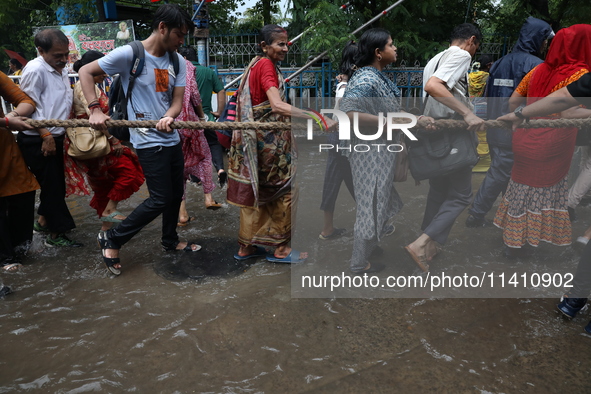 Hindu devotees are pulling the ''Rath'' or the chariot of Lord Jagannath, on the last day of the week-long celebration of Rath Yatra, or cha...