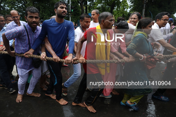 Hindu devotees are pulling the ''Rath'' or the chariot of Lord Jagannath, on the last day of the week-long celebration of Rath Yatra, or cha...