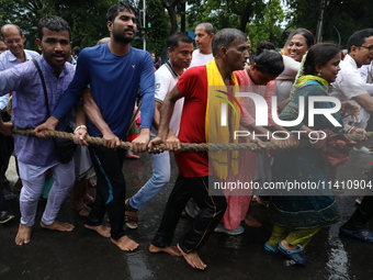 Hindu devotees are pulling the ''Rath'' or the chariot of Lord Jagannath, on the last day of the week-long celebration of Rath Yatra, or cha...