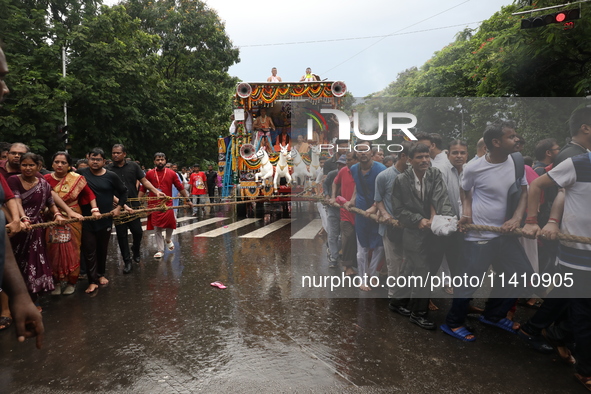 Hindu devotees are pulling the ''Rath'' or the chariot of Lord Jagannath, on the last day of the week-long celebration of Rath Yatra, or cha...