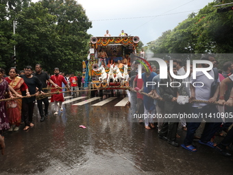 Hindu devotees are pulling the ''Rath'' or the chariot of Lord Jagannath, on the last day of the week-long celebration of Rath Yatra, or cha...