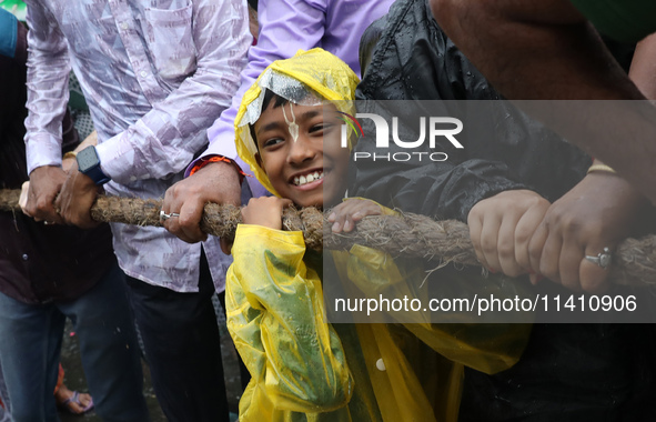 A Hindu boy is pulling a ''Rath'', or the chariot of Lord Jagannath, to seek blessings on the last day of the week-long celebration of Lord...