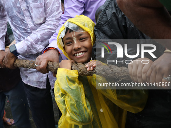 A Hindu boy is pulling a ''Rath'', or the chariot of Lord Jagannath, to seek blessings on the last day of the week-long celebration of Lord...