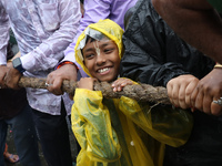 A Hindu boy is pulling a ''Rath'', or the chariot of Lord Jagannath, to seek blessings on the last day of the week-long celebration of Lord...