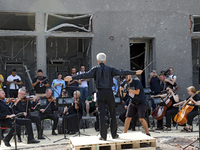 Conductor Herman Makarenko is directing the musicians of the Kyiv Classic Orchestra during the requiem for the victims of the Russian missil...