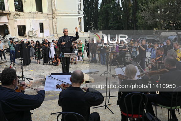 Conductor Herman Makarenko is directing the musicians of the Kyiv Classic Orchestra during the requiem for the victims of the Russian missil...