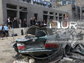 A crushed car is being pictured during the requiem for the victims of the Russian missile attack on the Ohmatdyt National Specialized Childr...