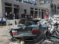 A crushed car is being pictured during the requiem for the victims of the Russian missile attack on the Ohmatdyt National Specialized Childr...