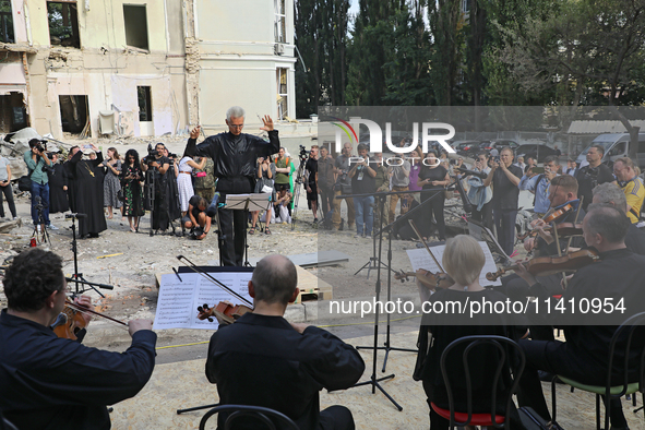 Conductor Herman Makarenko is directing the musicians of the Kyiv Classic Orchestra during the requiem for the victims of the Russian missil...