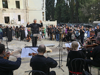 Conductor Herman Makarenko is directing the musicians of the Kyiv Classic Orchestra during the requiem for the victims of the Russian missil...