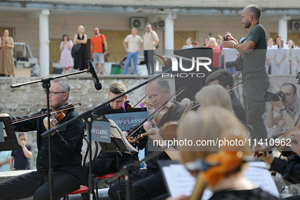 Musicians of the Kyiv Classic Orchestra are performing during the requiem for the victims of the Russian missile attack on the Ohmatdyt Nati...