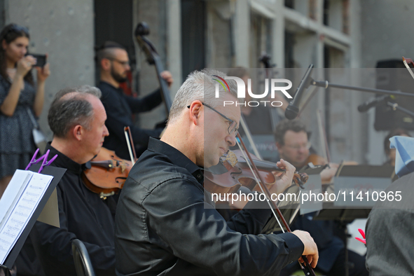 Musicians of the Kyiv Classic Orchestra are performing during the requiem for the victims of the Russian missile attack on the Ohmatdyt Nati...