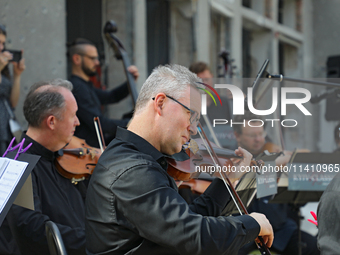 Musicians of the Kyiv Classic Orchestra are performing during the requiem for the victims of the Russian missile attack on the Ohmatdyt Nati...