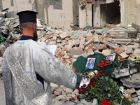 A priest is swinging the censer at the photographs of health professionals killed by the Russian missile attack on the Ohmatdyt National Spe...