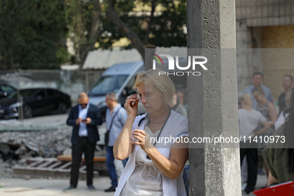 A health professional is wiping away tears during the requiem for the victims of the Russian missile attack on the Ohmatdyt National Special...