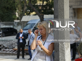 A health professional is wiping away tears during the requiem for the victims of the Russian missile attack on the Ohmatdyt National Special...