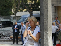 A health professional is wiping away tears during the requiem for the victims of the Russian missile attack on the Ohmatdyt National Special...