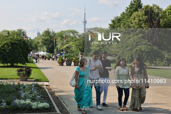 The CN Tower is appearing above the treetops from Centre Island in Toronto, Ontario, Canada, on July 13, 2024. 