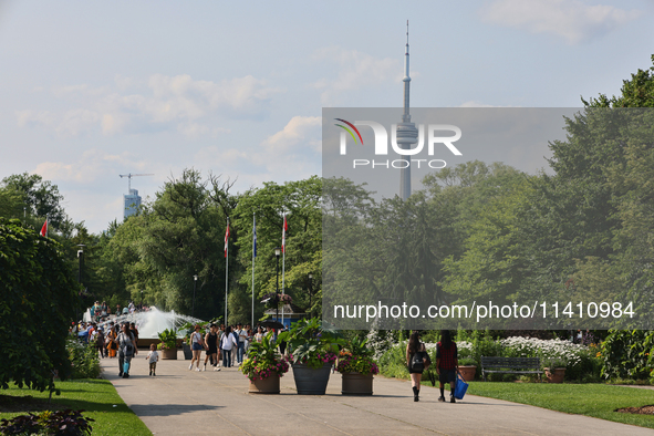 The CN Tower is appearing above the treetops from Centre Island in Toronto, Ontario, Canada, on July 13, 2024. 