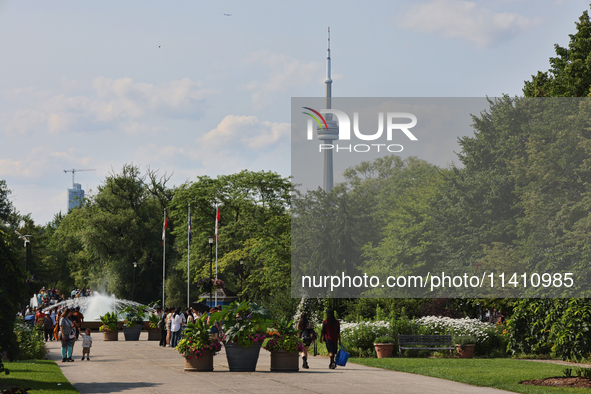 The CN Tower is appearing above the treetops from Centre Island in Toronto, Ontario, Canada, on July 13, 2024. 