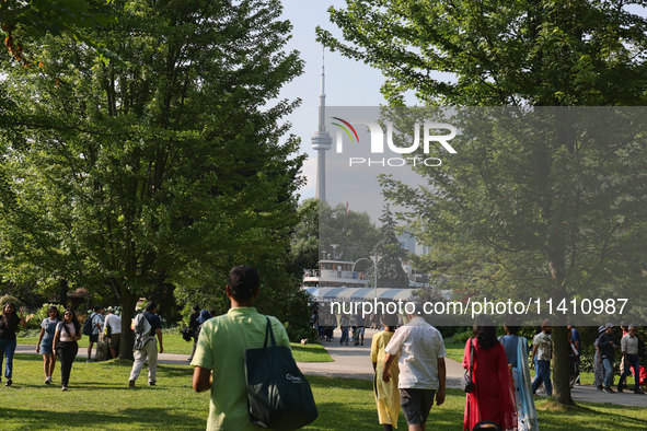 The CN Tower is appearing above the treetops from Centre Island in Toronto, Ontario, Canada, on July 13, 2024. 