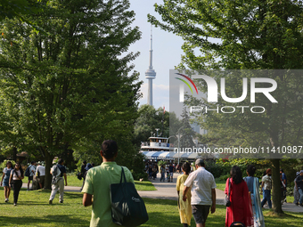 The CN Tower is appearing above the treetops from Centre Island in Toronto, Ontario, Canada, on July 13, 2024. (