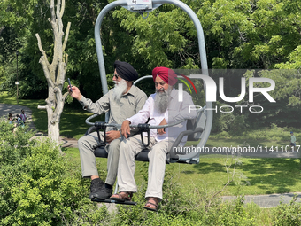 Elderly Sikh men are enjoying the skyride on Centre Island in Toronto, Ontario, Canada, on July 13, 2024. (