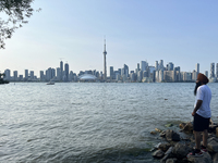 A Sikh man is looking out at the skyline of the city of Toronto seen from Centre Island in Toronto, Ontario, Canada, on July 13, 2024. (