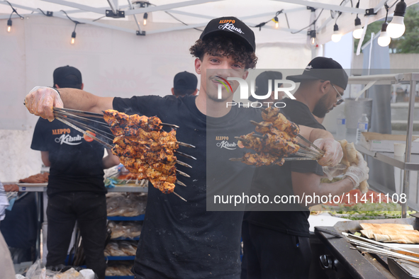 A man is grilling Syrian Aleppo-style kabobs during the Taste of the Middle East Food Festival in Toronto, Ontario, Canada, on July 06, 2024...