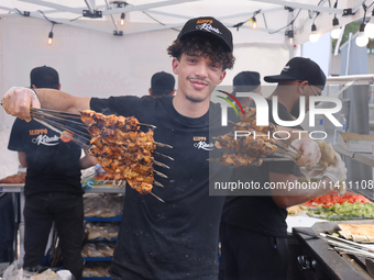 A man is grilling Syrian Aleppo-style kabobs during the Taste of the Middle East Food Festival in Toronto, Ontario, Canada, on July 06, 2024...