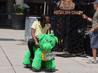 A man is riding on a motorized stuffed animal during the Taste of the Middle East Food Festival in Toronto, Ontario, Canada, on July 06, 202...